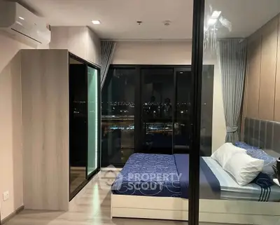 Modern bedroom with city view, featuring sleek design and floor-to-ceiling windows.