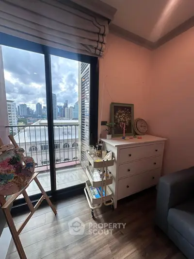 Charming city view from cozy living room with elegant decor and large window.