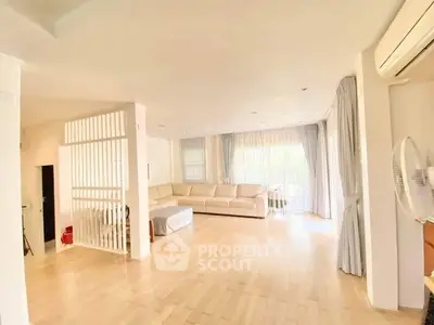 Spacious living room with natural light and modern decor