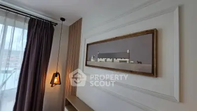 Stylish interior with modern pendant light and framed artwork, perfect for contemporary living.