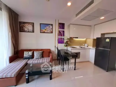 Modern open-layout living room and kitchen with stylish decor and natural light.
