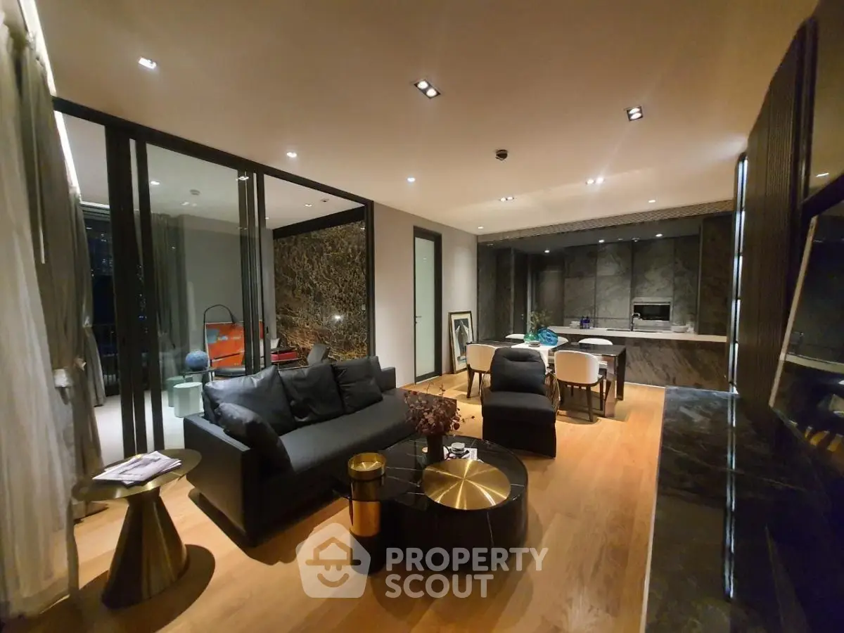 Luxurious modern living room with open layout and elegant decor, featuring a spacious balcony view.