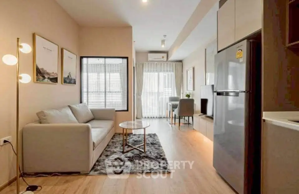 Modern living room with stylish decor and open kitchen layout in a cozy apartment.