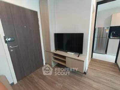 Modern apartment interior with sleek wooden flooring and stylish TV setup