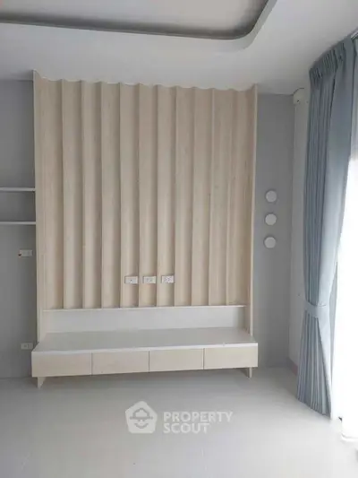Modern minimalist bedroom with elegant wood paneling and natural light