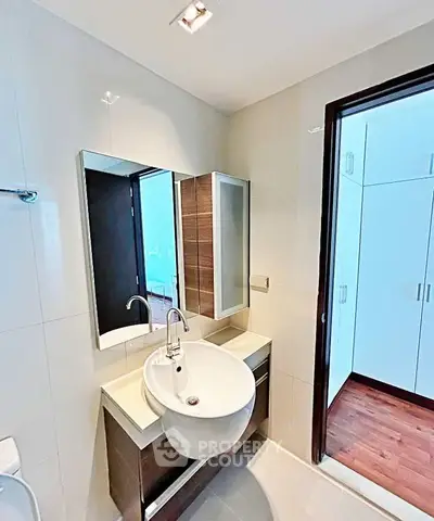 Modern bathroom with sleek sink and mirror in contemporary apartment