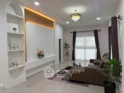 Elegant living room with modern decor and stylish lighting, featuring a cozy sofa and decorative plants.