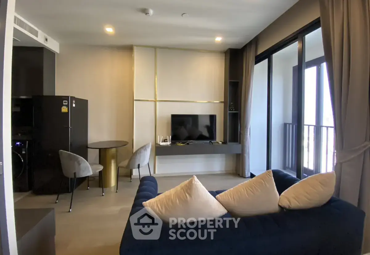 Modern living room with stylish decor and balcony access in a luxury apartment.