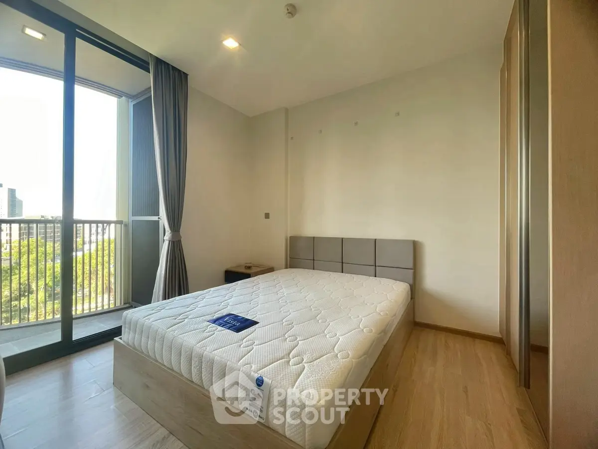 Modern bedroom with balcony view and stylish furnishings in a bright apartment