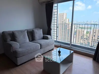Modern living room with stunning city view from high-rise apartment window.