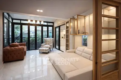 Spacious modern living room with elegant furniture and large windows for natural light.