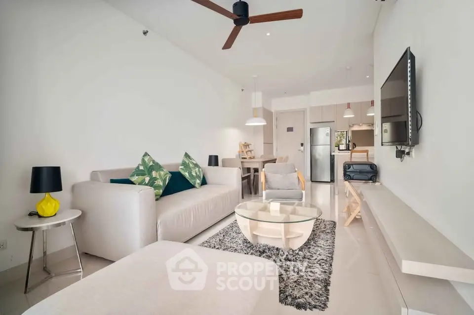 Modern living room with stylish decor and open kitchen layout in a contemporary apartment.