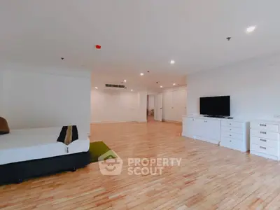 Spacious modern living room with hardwood floors and sleek furniture