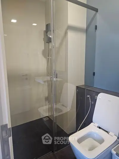 Modern bathroom with glass shower and sleek toilet design