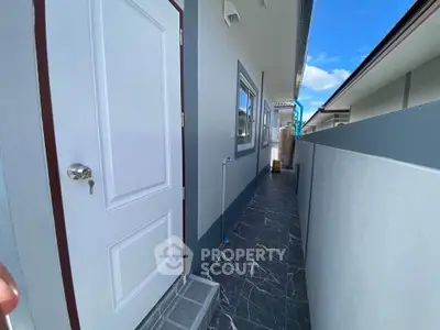 Modern exterior corridor with sleek design and white door