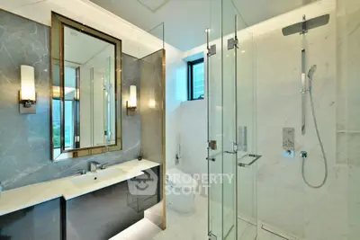 Luxurious modern bathroom with glass shower and elegant fixtures