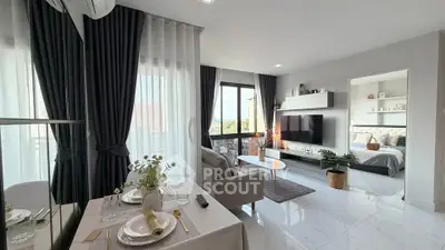 Modern open-plan living room with elegant decor and natural light