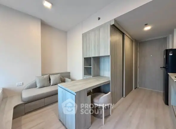 Modern living room with sleek furniture and built-in storage in a stylish apartment.