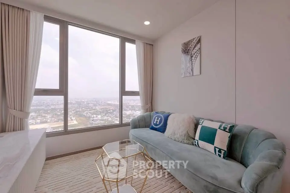 Modern living room with panoramic city view, stylish sofa, and elegant decor in high-rise apartment.