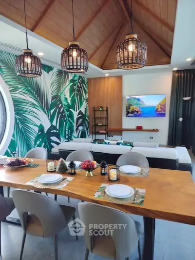 Luxurious living room with tropical decor, vaulted ceiling, and elegant dining area, perfect for entertaining.