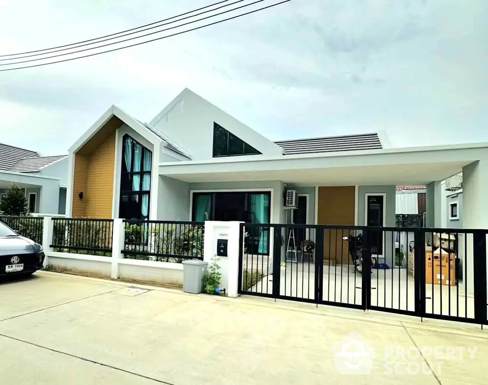 Modern single-story house with sleek design and spacious driveway