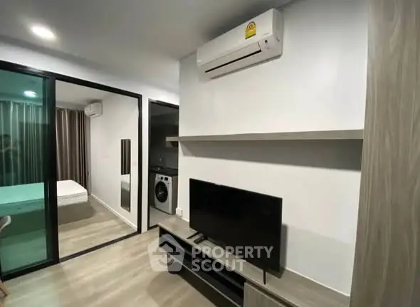 Modern living room with air conditioning and sleek furniture in a stylish apartment.