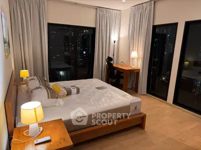 Luxurious bedroom with city view, featuring elegant wooden furniture and ambient lighting for a cozy atmosphere.
