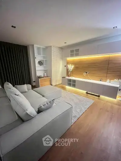 Modern living room with sleek design, cozy sofa, and ambient lighting for a stylish home experience.