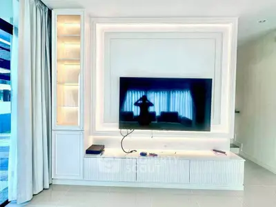 Modern living room with sleek TV setup and elegant lighting