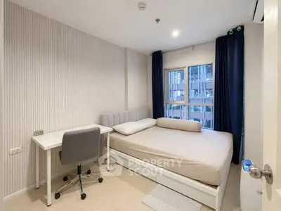 Modern bedroom with study area, featuring a cozy bed and sleek desk in a bright apartment.