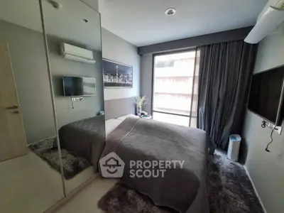 Modern bedroom with large mirror and cozy decor in urban apartment