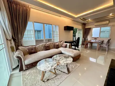 Luxurious living room with elegant sofa and modern decor in a spacious open layout.