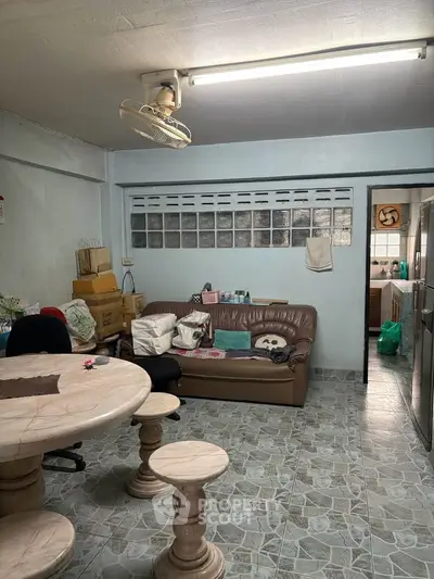 Cozy living room with marble table and leather sofa, ideal for relaxation and gatherings.