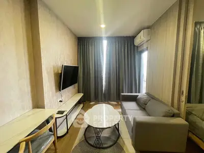 Modern living room with stylish furniture and wall-mounted TV, featuring elegant curtains and cozy ambiance.