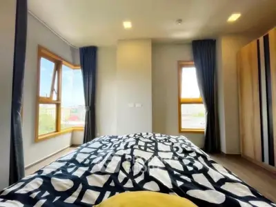 Bright bedroom with large windows and modern decor