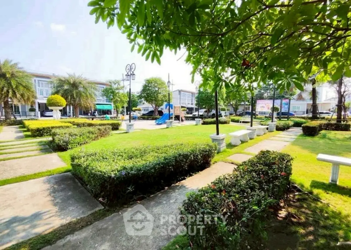 Charming residential park with lush greenery and playground, perfect for family living.