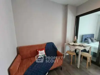 Cozy living room with modern decor and adjacent dining area in a stylish apartment.