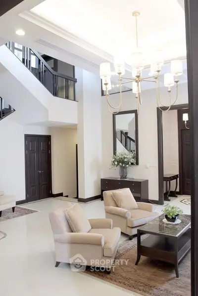 Luxurious living room with elegant chandelier and plush seating in a modern home