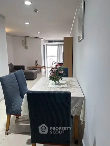 Modern dining area with elegant table setting in a cozy apartment interior.