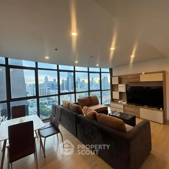 Stunning city view from modern living room with large windows and stylish furniture.