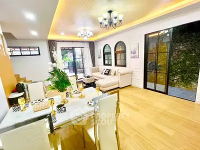 Luxurious open-plan living and dining area with elegant decor and natural light.