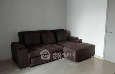 Modern living room with sleek brown sectional sofa and minimalist decor.