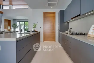 Modern kitchen with sleek cabinetry and gas stove in luxury home