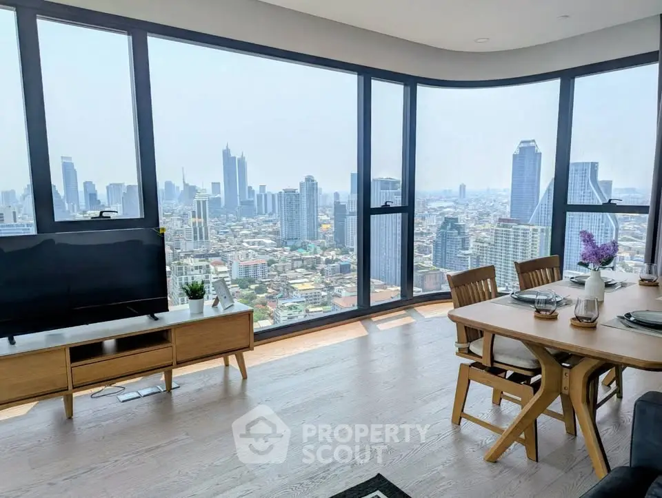 Stunning corner unit with panoramic city views, spacious living and dining area, modern furnishings, and floor-to-ceiling windows.