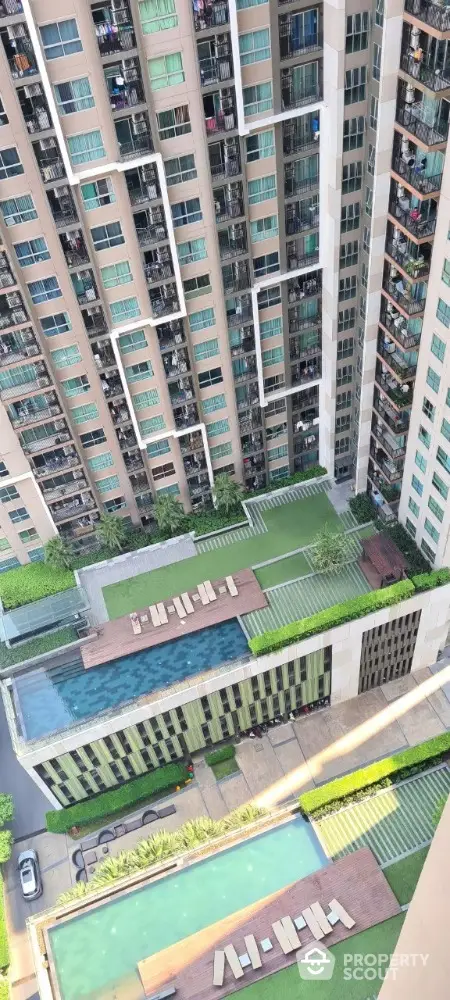 Stunning aerial view of modern high-rise residential complex with luxurious swimming pools and landscaped gardens.