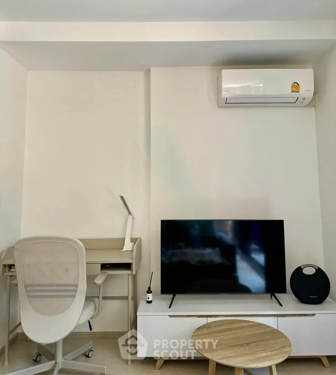 Modern living room with sleek furniture and air conditioning unit, perfect for comfort and style.