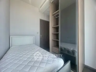 Cozy bedroom with modern wardrobe and comfortable bed in a bright apartment.