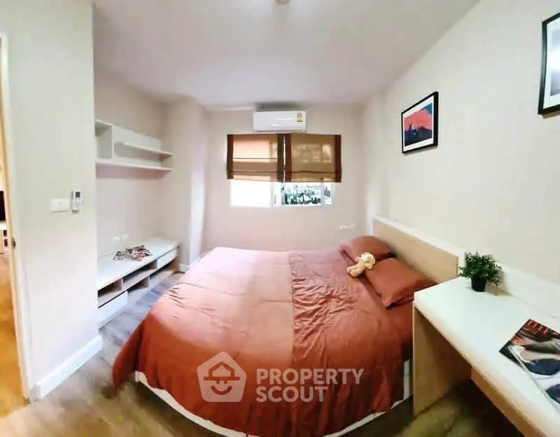 Cozy bedroom with modern decor and natural light, perfect for relaxation.