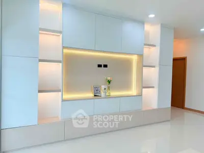 Modern minimalist living room with built-in shelving and soft lighting