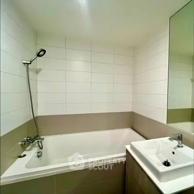 Modern bathroom with bathtub and sleek fixtures in a contemporary apartment.